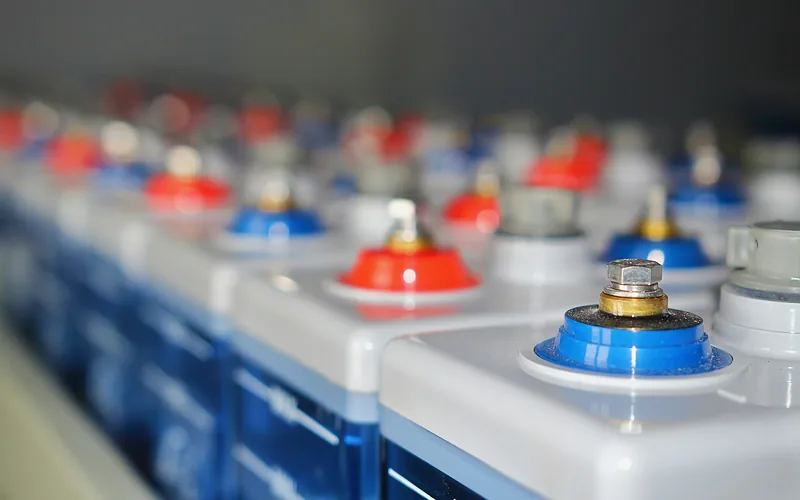 Rows of lead-acid batteries with red and blue terminals
