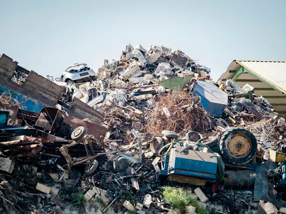 Large pile of mixed scrap metal at a scrapyard